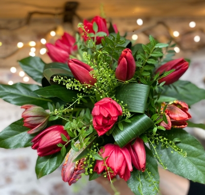 12 red tulips in an included eco recycled glass vase.