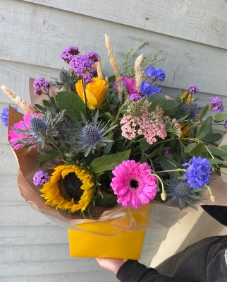 Bright gift boxed florists choice bouquet with sunflowers.