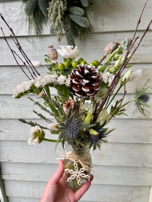 Festive jar of flowers.