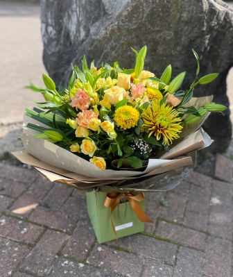 Large luxury golden bouquet hand tied and presented in a gift box with water.