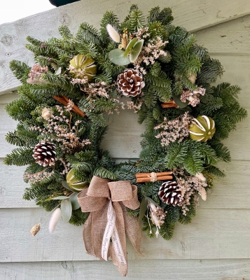 Spruce door wreath with dried flowers and limes.