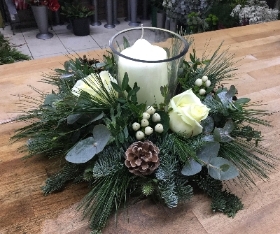 Hurricane lamp table decoration of fresh roses and foliage with a candle. (Size approx 12” across).