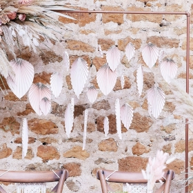 Blush pink paper palm backdrop. Each pack contains 25 paper fan decorations.