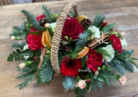 Festive trug basket arrangement in oasis.